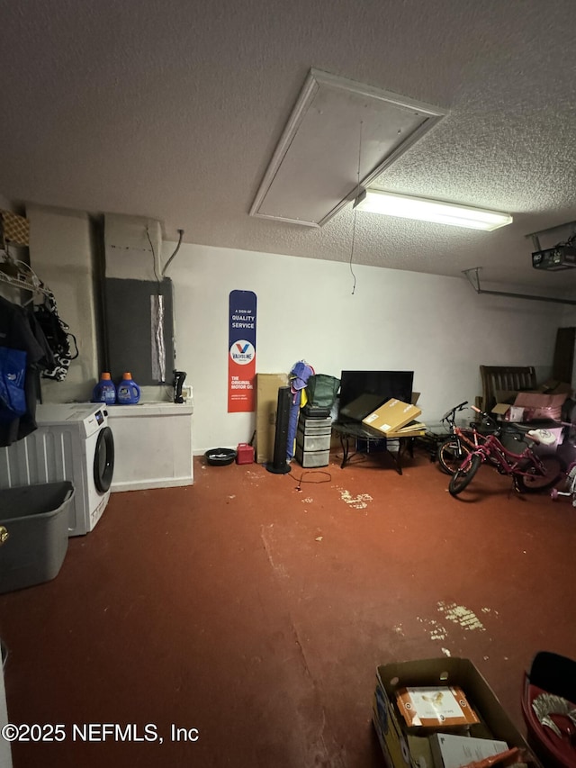 basement with separate washer and dryer and a textured ceiling