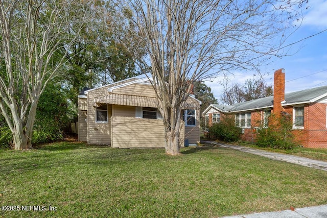 view of side of property with a yard