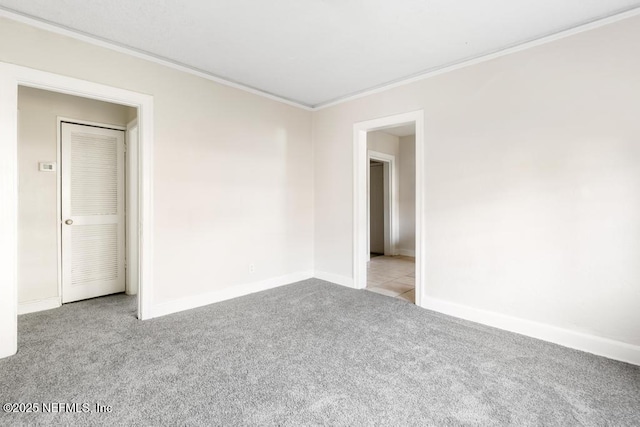 carpeted spare room with crown molding