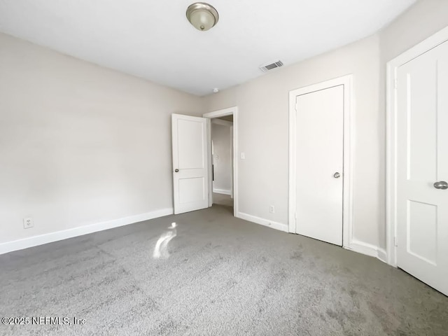 unfurnished bedroom with dark colored carpet