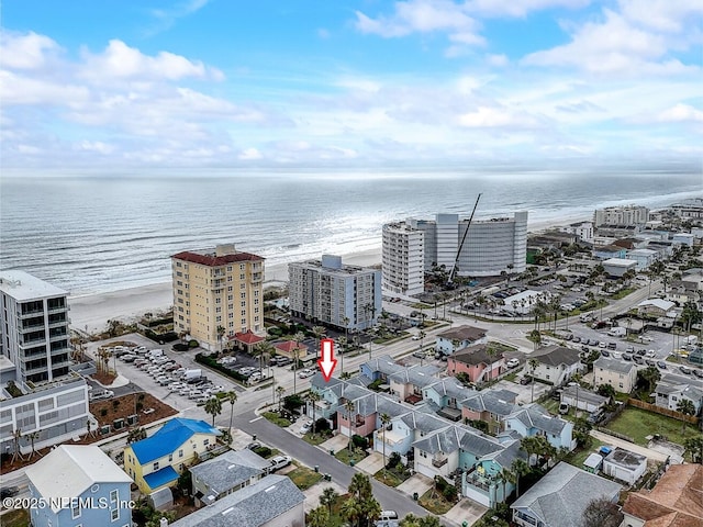 drone / aerial view featuring a beach view and a water view