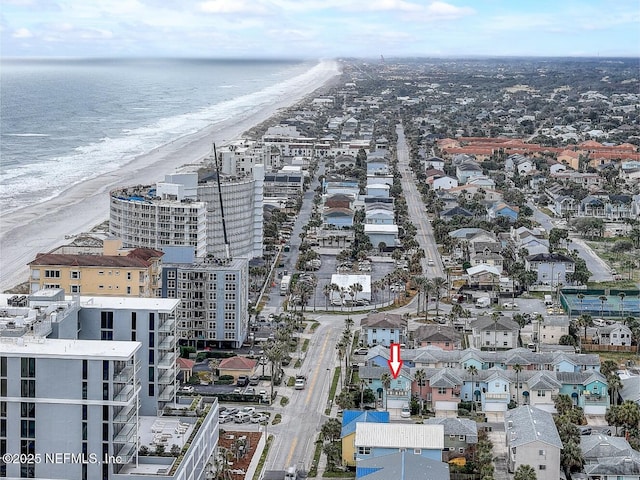 aerial view with a water view and a view of the beach