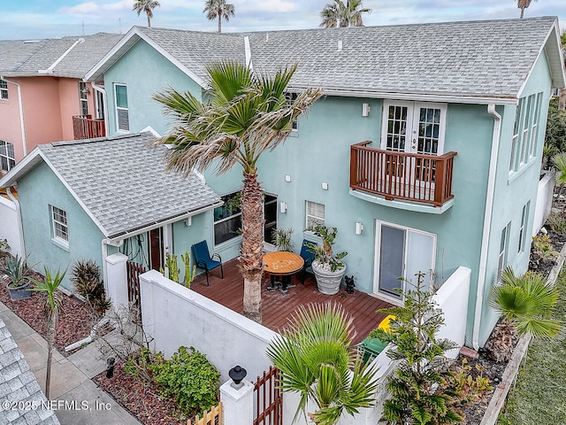 view of front of property featuring french doors and a balcony