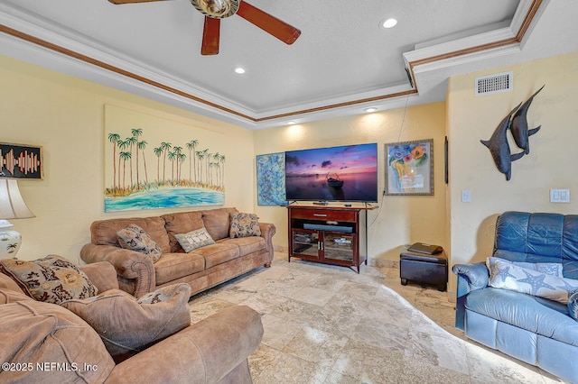 living room with crown molding, ceiling fan, and a tray ceiling