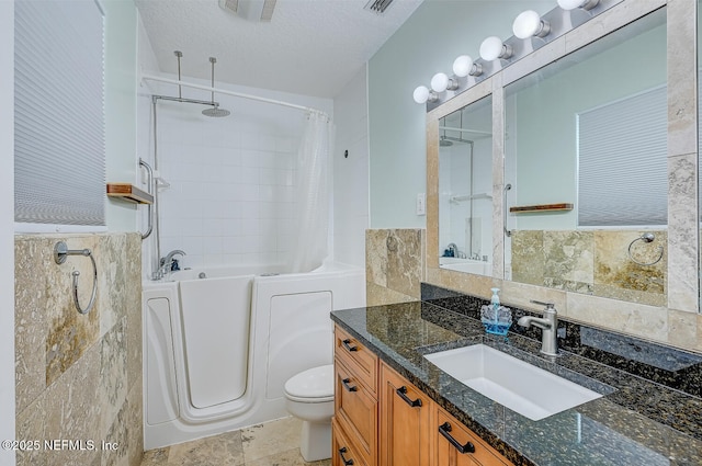 full bathroom with vanity, toilet, a textured ceiling, and plus walk in shower