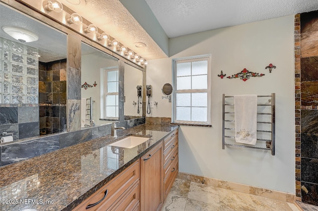 bathroom featuring vanity and a textured ceiling