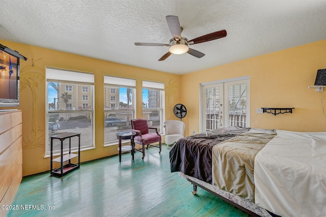 bedroom with hardwood / wood-style floors, french doors, a textured ceiling, and ceiling fan