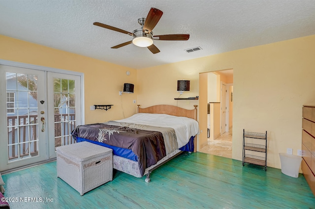 bedroom with wood-type flooring, access to exterior, a textured ceiling, and french doors