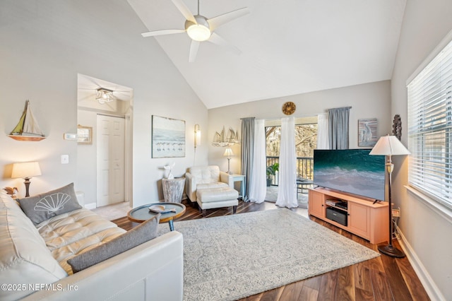 living room with hardwood / wood-style flooring, ceiling fan, and high vaulted ceiling