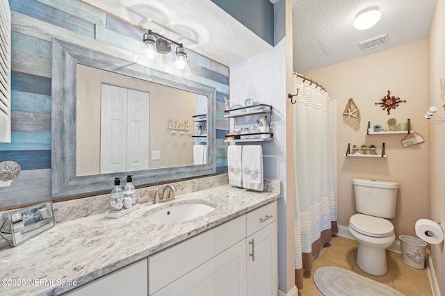 bathroom with tile patterned floors, toilet, a textured ceiling, vanity, and a shower with shower curtain