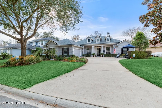 view of front of home with a garage and a front lawn