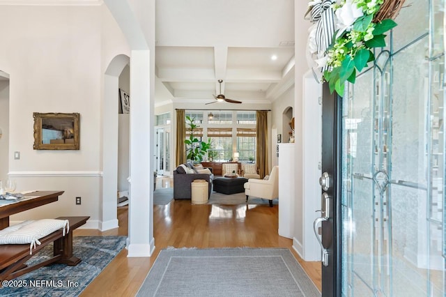 entrance foyer featuring beamed ceiling, ceiling fan, coffered ceiling, and light hardwood / wood-style floors