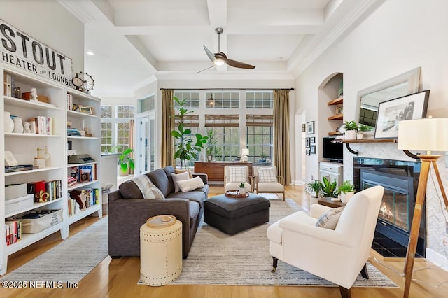 sitting room with coffered ceiling, beamed ceiling, ceiling fan, and light wood-type flooring