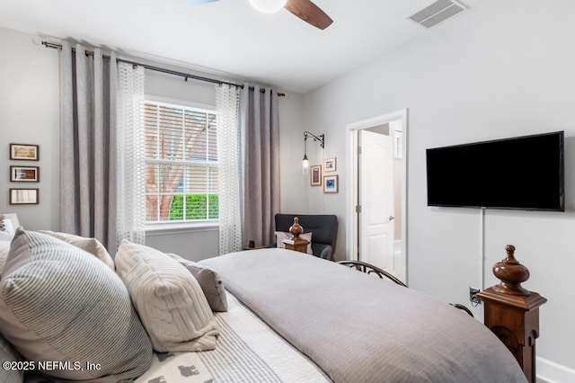 bedroom with ceiling fan and ensuite bath