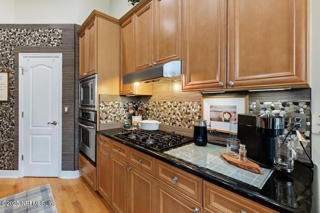 kitchen featuring tasteful backsplash, appliances with stainless steel finishes, and light hardwood / wood-style floors