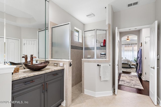 bathroom with vanity, plenty of natural light, tile patterned floors, and a tile shower