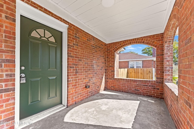 view of exterior entry featuring a porch