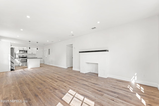 unfurnished living room with light hardwood / wood-style flooring