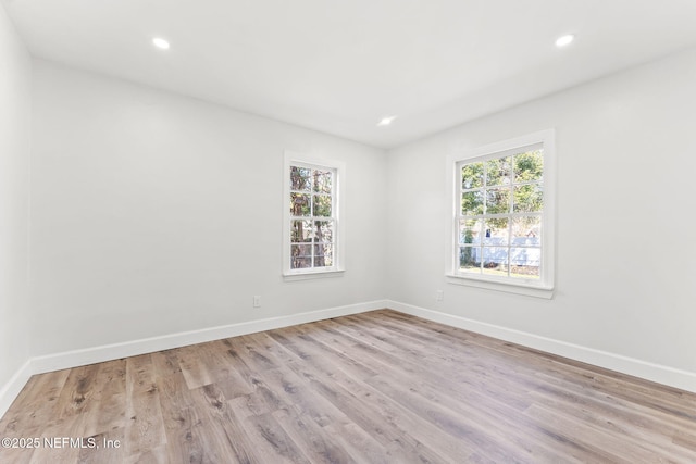 empty room with light hardwood / wood-style floors