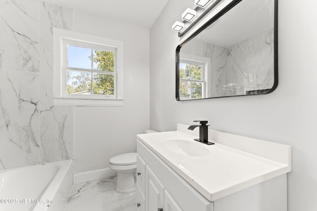 bathroom featuring vanity, plenty of natural light, and toilet