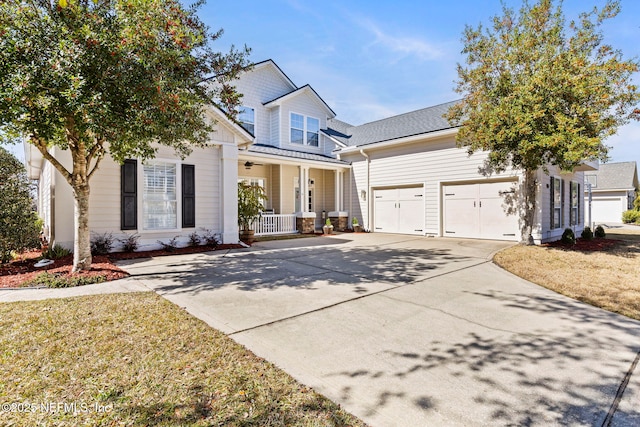 view of front of home featuring a porch, a garage, and a front yard