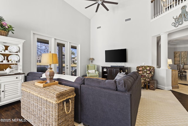 living room with french doors, high vaulted ceiling, dark hardwood / wood-style floors, ceiling fan, and decorative columns