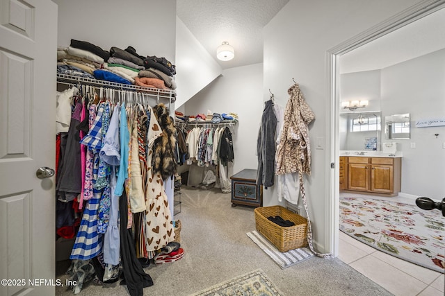 spacious closet featuring light colored carpet