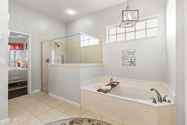 bathroom with a chandelier, independent shower and bath, tile patterned flooring, and a textured ceiling