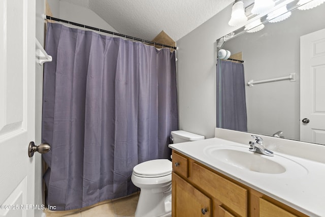 bathroom with vanity, a textured ceiling, and toilet