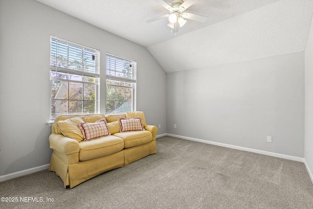 living area with lofted ceiling, ceiling fan, a textured ceiling, and carpet flooring