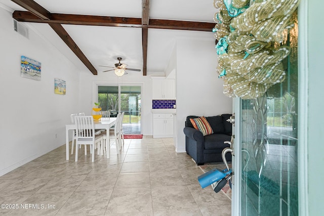 tiled dining room featuring ceiling fan and beamed ceiling