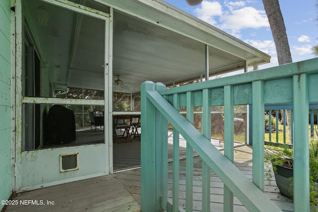 wooden deck featuring ceiling fan