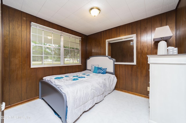 bedroom with wood walls