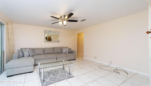 tiled living room with ceiling fan