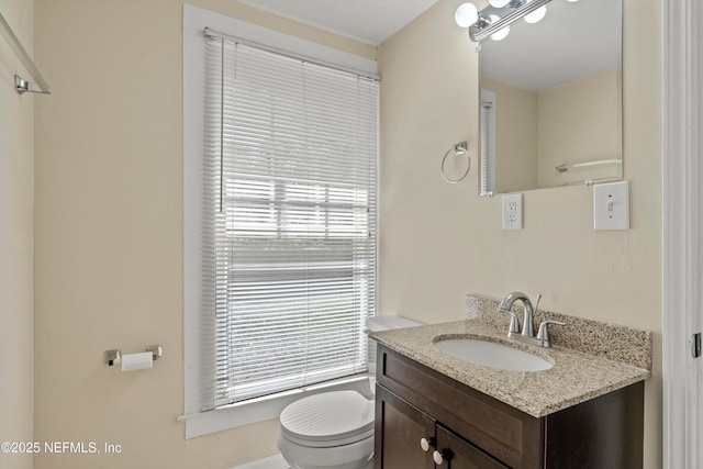 bathroom featuring toilet and vanity