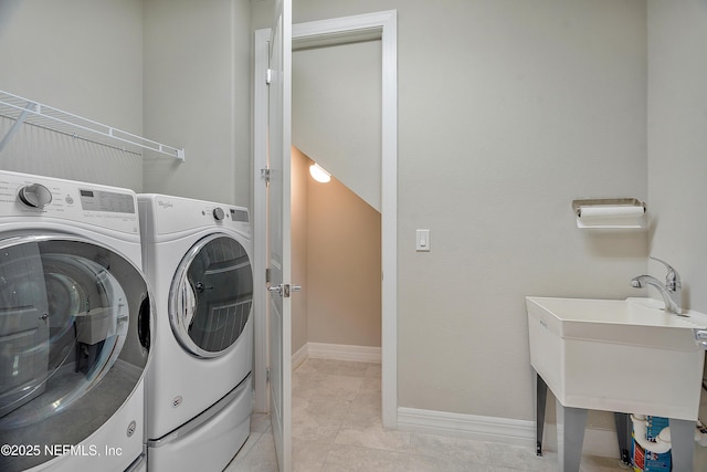 laundry area with separate washer and dryer and light tile patterned floors