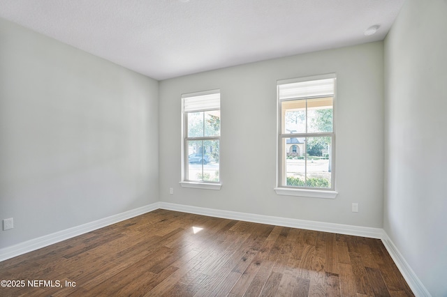 spare room with hardwood / wood-style flooring and a textured ceiling