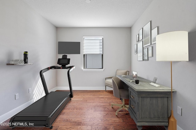 office space featuring wood-type flooring and a textured ceiling