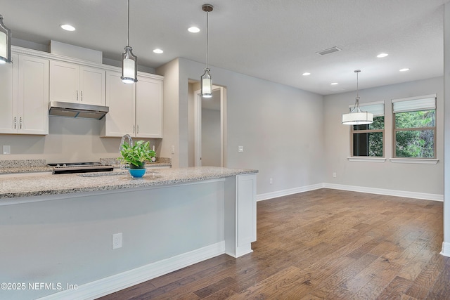 kitchen featuring pendant lighting, white cabinetry, dark hardwood / wood-style flooring, light stone countertops, and a textured ceiling