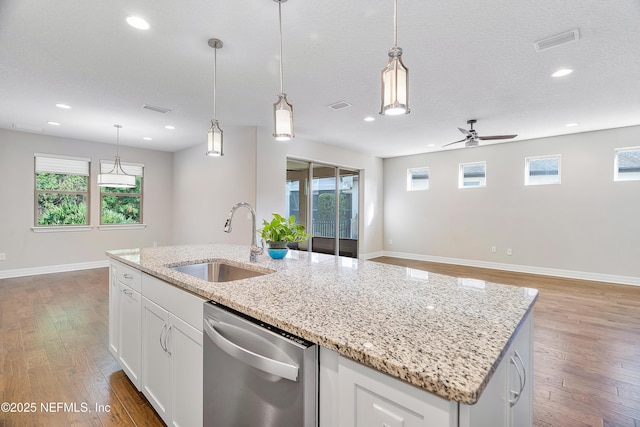 kitchen with dishwasher, sink, pendant lighting, and white cabinets