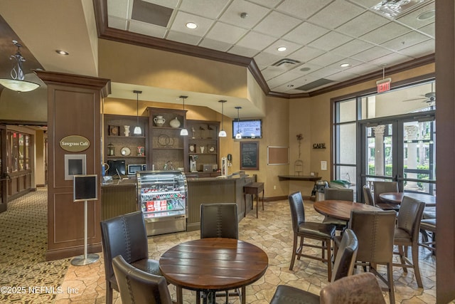 dining space with crown molding, a paneled ceiling, and french doors