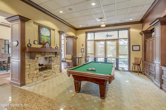 game room featuring billiards, a stone fireplace, ornate columns, a paneled ceiling, and ornamental molding