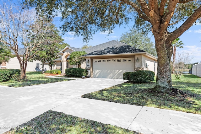 view of front of house with a garage, concrete driveway, and stucco siding