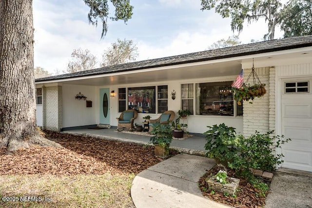 property entrance featuring a garage and covered porch