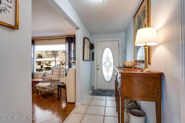 foyer featuring light parquet flooring and a healthy amount of sunlight