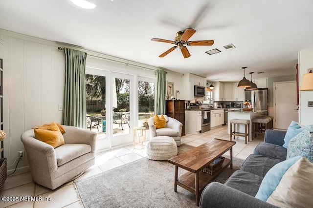 tiled living room featuring ceiling fan