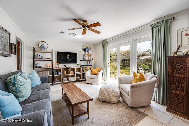 living room featuring crown molding, light tile patterned floors, and ceiling fan