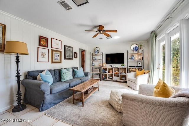 tiled living room with crown molding and ceiling fan