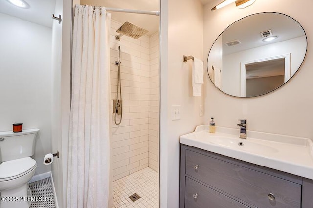 bathroom with toilet, vanity, and walk in shower