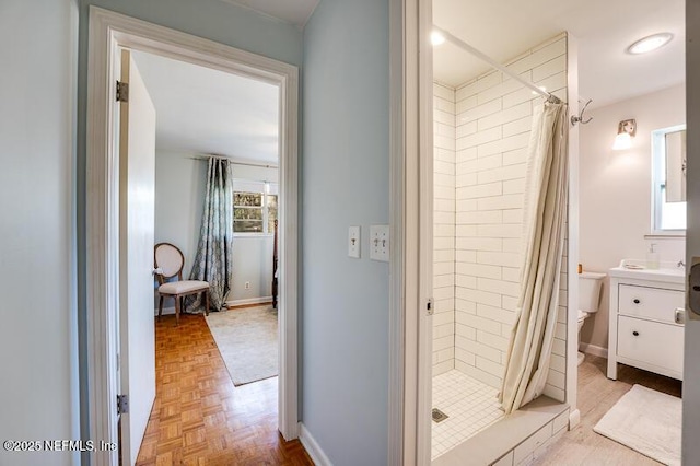 bathroom featuring vanity, parquet floors, a shower with curtain, and toilet